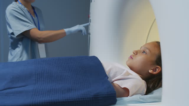 A child enters an MRI machine for a medical scan.